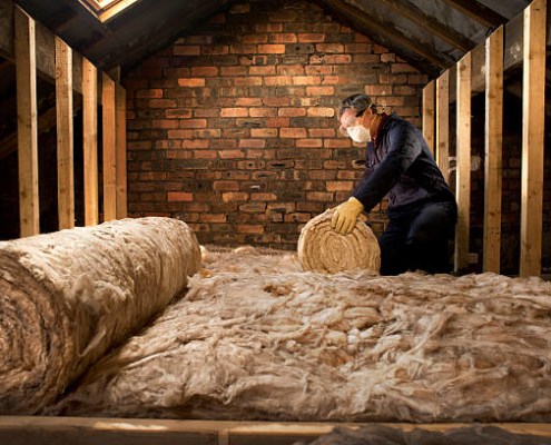 man puts insulation in his loft