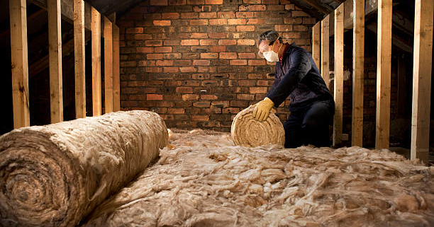 man puts insulation in his loft